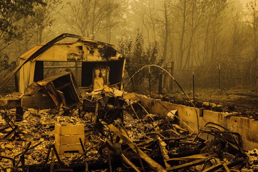 Water continues to flow from a pipe amid the charred remains of homes and businesses after the passage of the Santiam Fire in Gates, Oregon, on September 10, 2020. - California firefighters battled the state's largest ever inferno on September 10, as tens of thousands of people fled blazes up and down the US West Coast and officials warned the death toll could shoot up in coming days. At least eight people have been confirmed dead in the past 24 hours across California, Oregon and Washington, but officials say some areas are still impossible to reach, meaning the number is likely to rise. (Photo by Kathryn ELSESSER / AFP) (Photo by KATHRYN ELSESSER/AFP via Getty Images)