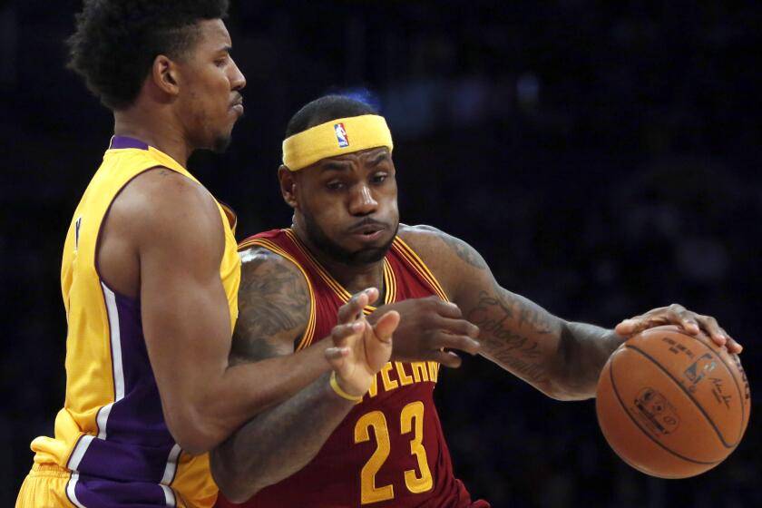 Lakers forward Nick Young tries to cut off a drive by Cavaliers forward LeBron James during their game last month at Staples Center.
