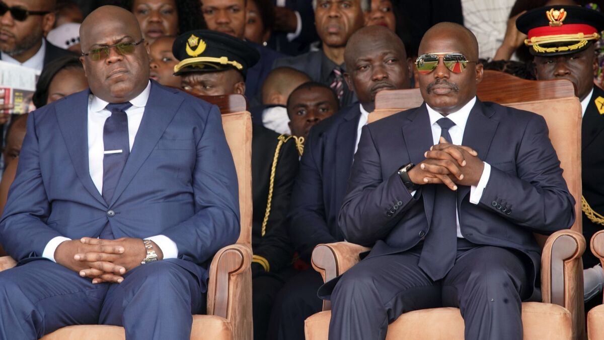 Congolese President Felix Tshisekedi, left, and outgoing president Joseph Kabila sit side by side during the inauguration ceremony in Kinshasa, Democratic Republic of the Congo on Jan. 24.