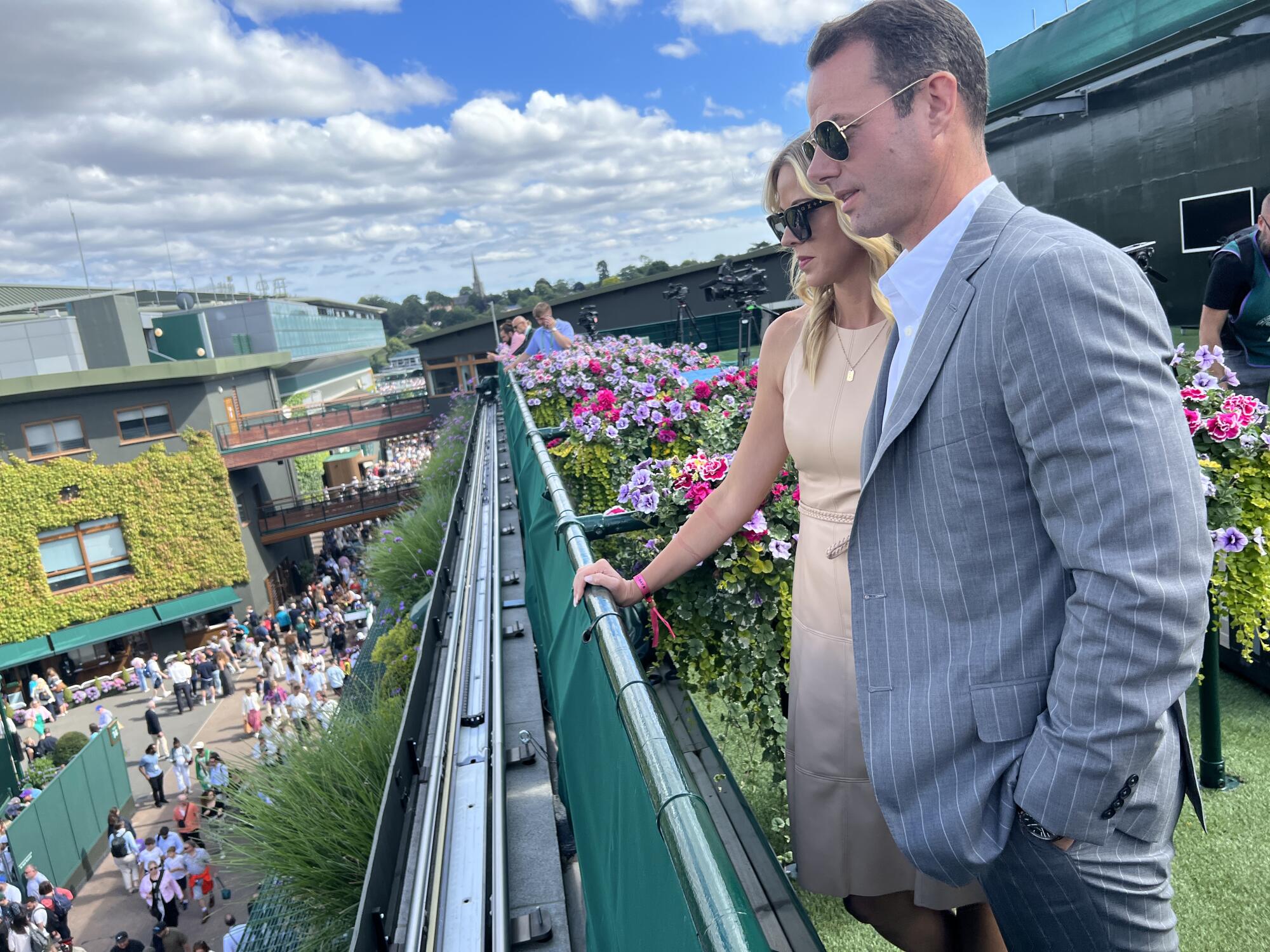 Brandon and Amy Staley look over a railing at Wimbledon.