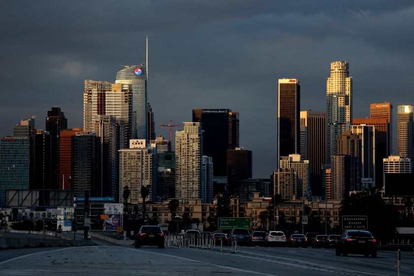 LOS ANGELES, CA - FEBRUARY 26: Clouds hover in the background of downtown Los Angeles skyline after a powerful winter storm passed though over the weekend causing flooding and power outages in some areas on Sunday, Feb. 26, 2023 in Los Angeles, CA. A powerful winter storm system that forecasters say will bring an extended period of cold temperatures, high winds and snow, prompting the region's first blizzard warning on record. (Gary Coronado / Los Angeles Times)