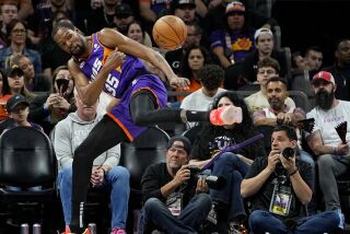 Kevin Durant, alero de los Suns de Phoenix, trata de evitar que el balón salga en el partido ante los Nuggets de Denver, el viernes 31 de marzo de 2023 (AP Foto/Matt York)