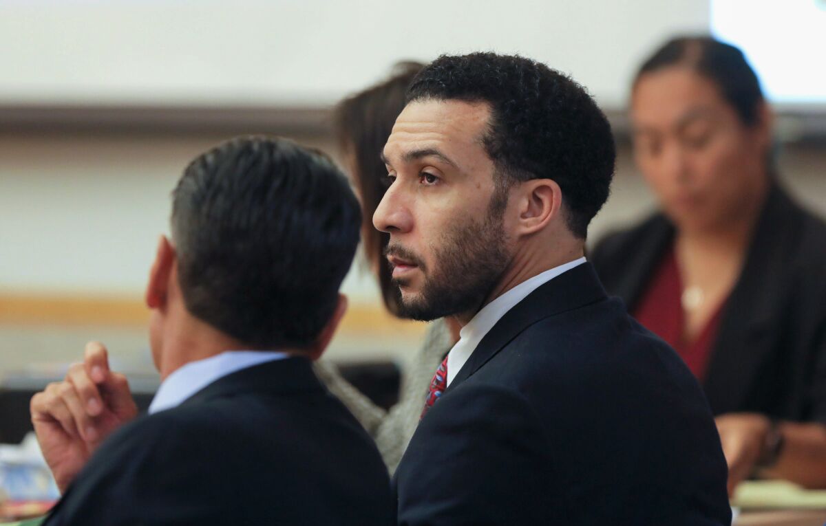 Kellen Winslow II listens with this attorneys Marc Carlos, left, and Gretchen von Helms (behind Winslow) during discussions prior to opening statements in the first day of his retrial at the Vista Courthouse on Monday, Nov. 4, 2019.