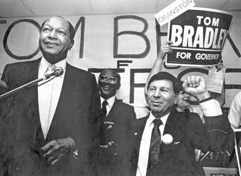 Los Angeles Mayor Tom Bradley, left, is shown in his San Diego headquarters during his run for governor in 1986 with Assemblyman Peter Chacon, right.