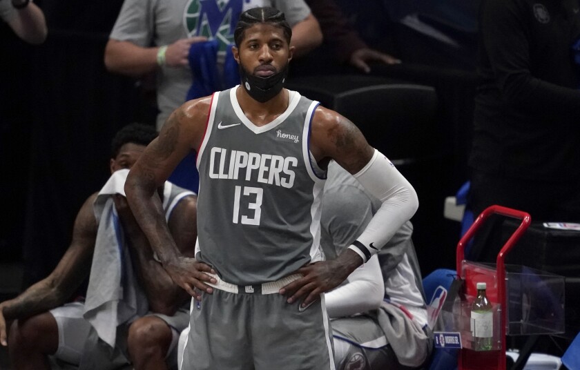 Clippers' Paul George watches play with his hands on his hips in the closing seconds of a game against Dallas.