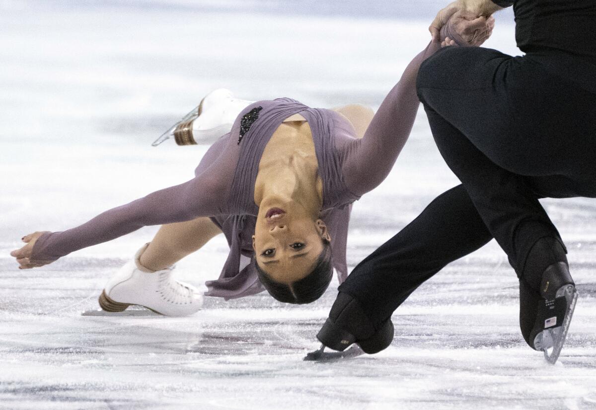 FILE - In this Oct. 25, 2019, file photo, Jessica Calalang and Brian Johnson, of the United States, perform their short program in the pairs competition at the Skate Canada figure skating event in Kelowna, British Columbia. Calalang, a U.S. pairs skater and potential member of the team for next February's Winter Games in Beijing, recently had a suspension from the sport overturned. Calalang had tested positive for a banned substance in January at the national championships, and it took eight months for her name to be cleared. (Paul Chiasson/The Canadian Press via AP, File)