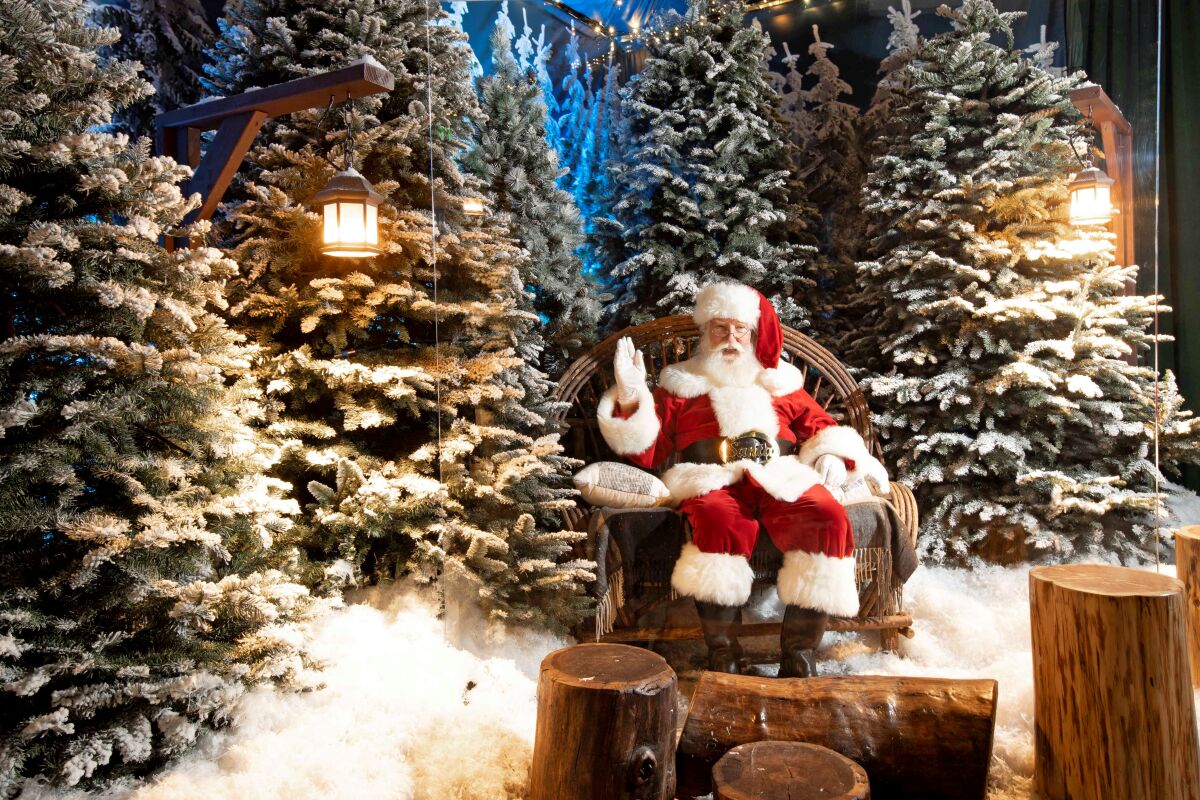 Santa Claus seated against a snowy backdrop.