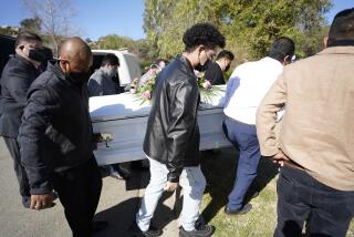 San Diego, California - February 26: Daniel Rivera used to co-preach with his father every Sunday. Recently both of Daniels parents have passed away from COVID-19. Family and friends attend the funeral for Pastors Taurino and Silvia Rivera at Singing Hills Memorial Park on Friday, Feb. 26, 2021 in San Diego, California. The casket of Silvia Rivera is carried our of the hearse. (Alejandro Tamayo / The San Diego Union-Tribune)