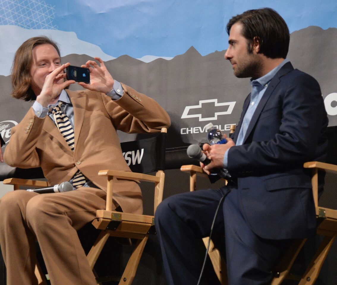 Director Wes Anderson, left, and actor Jason Schwartzman participate in discussion about the film "The Grand Budapest Hotel."