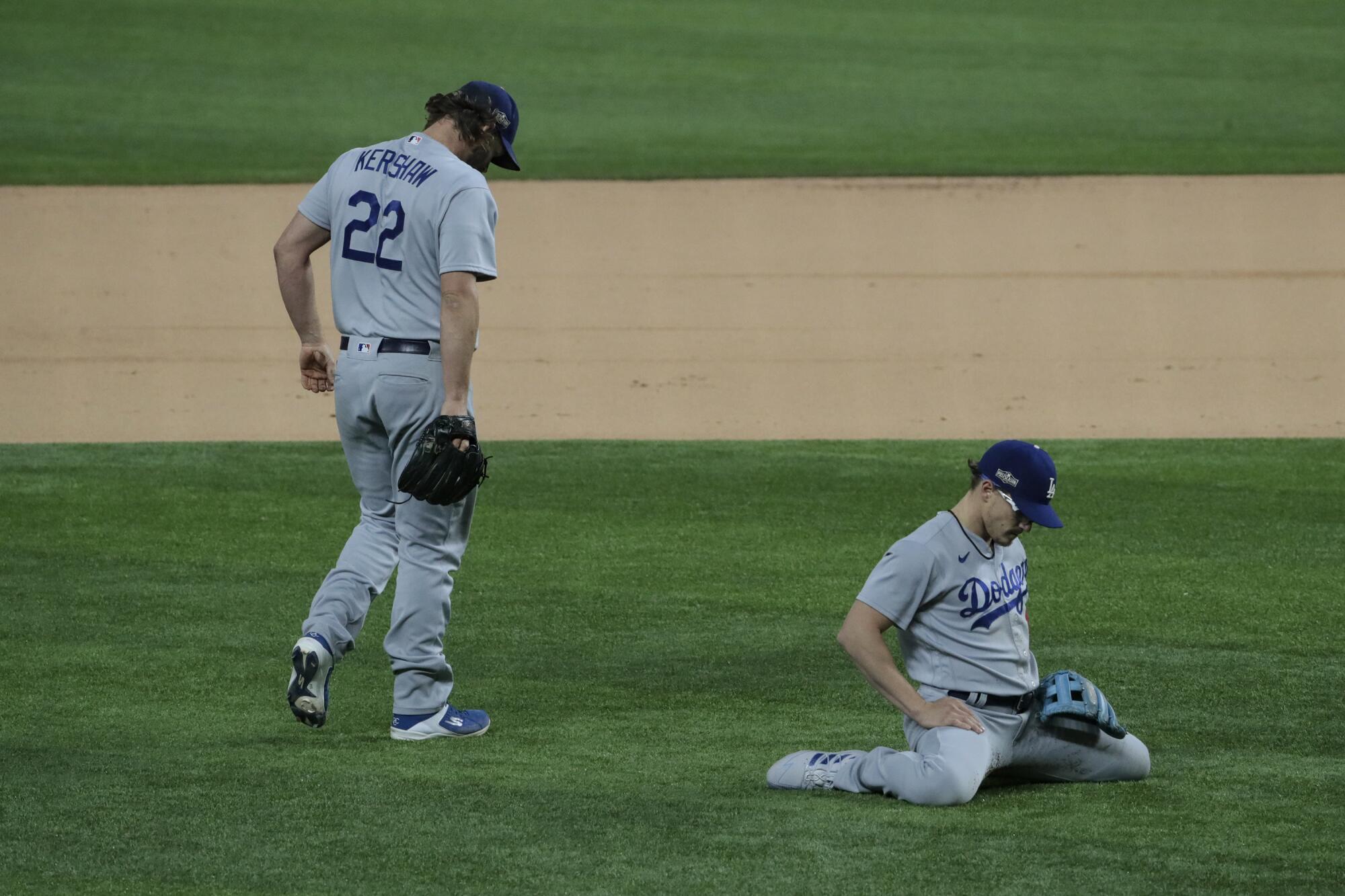 Dodgers pitcher Clayton Kershaw and shortstop Kike Hernandez can't make a play on an infield single.