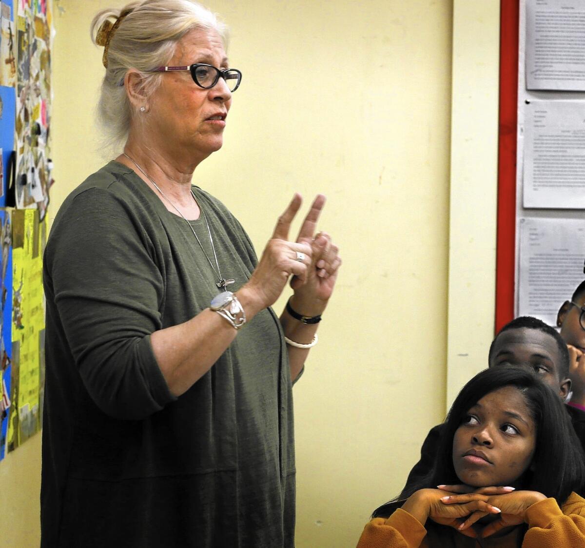 Westchester High School senior Mikayla Smith, right, and her English composition classmates listen to teacher Johanna Bernstein, who began using the restorative justice ritual last year.