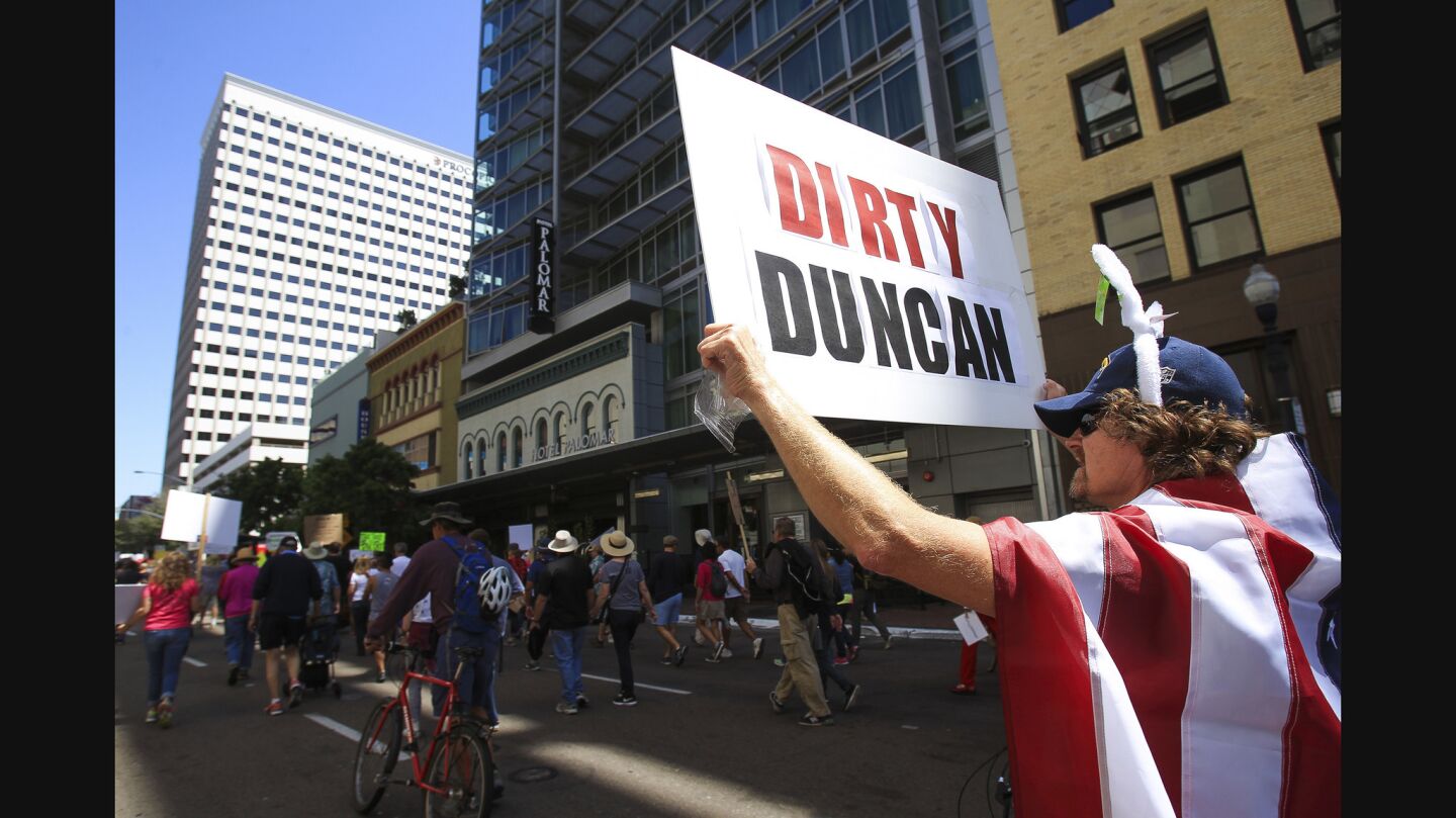 Aaron Townsend holds a sign in reference to Congressman Duncan Hunter.