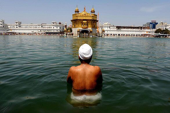 A Sikh devotee takes a dip in the holy water tank as he pays his respects at the Golden Temple on Wednesday during Baisakhi festival marking the Punjabi and Nepalese New Year and the beginning of the harvest season.