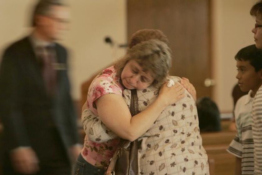 People gather to mourn the death of Sandra Cantu at Fry Memorial Chapel in Tracy, Calif. The 8-year-old had been reported missing in late March, and her body was found inside a suitcase in an irrigation pond April 6. Related: Tracy slaying suspect's family tries to fit accusations with woman they know