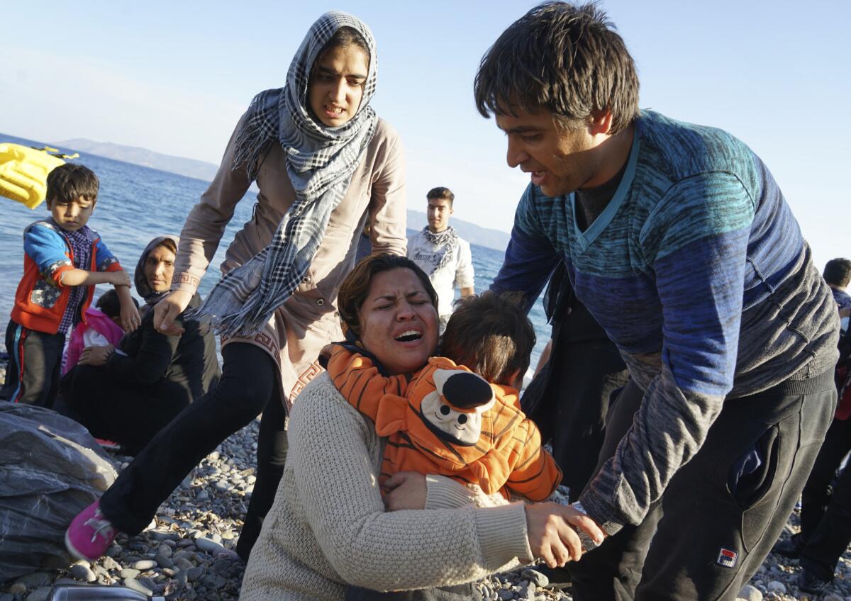 Family members embrace in relief after reaching Lesbos.
