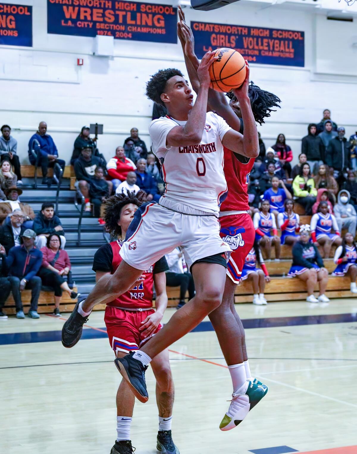 Alijah Arenas of Chatsworth flies through the air against Washington Prep.