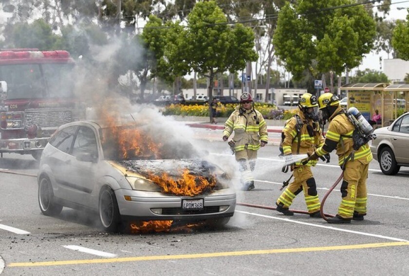 Costa Mesa Firefighters put out a car fire on Fairview Road across from Costa Mesa High School on Tuesday.