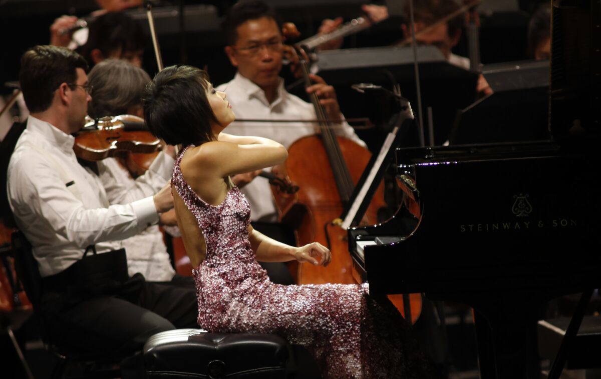 Pianist Yuja Wang performs Ravel's Concerto in G with the Los Angeles Philharmonic conducted by Gustavo Dudamel at the Hollywood Bowl on Thursday night.