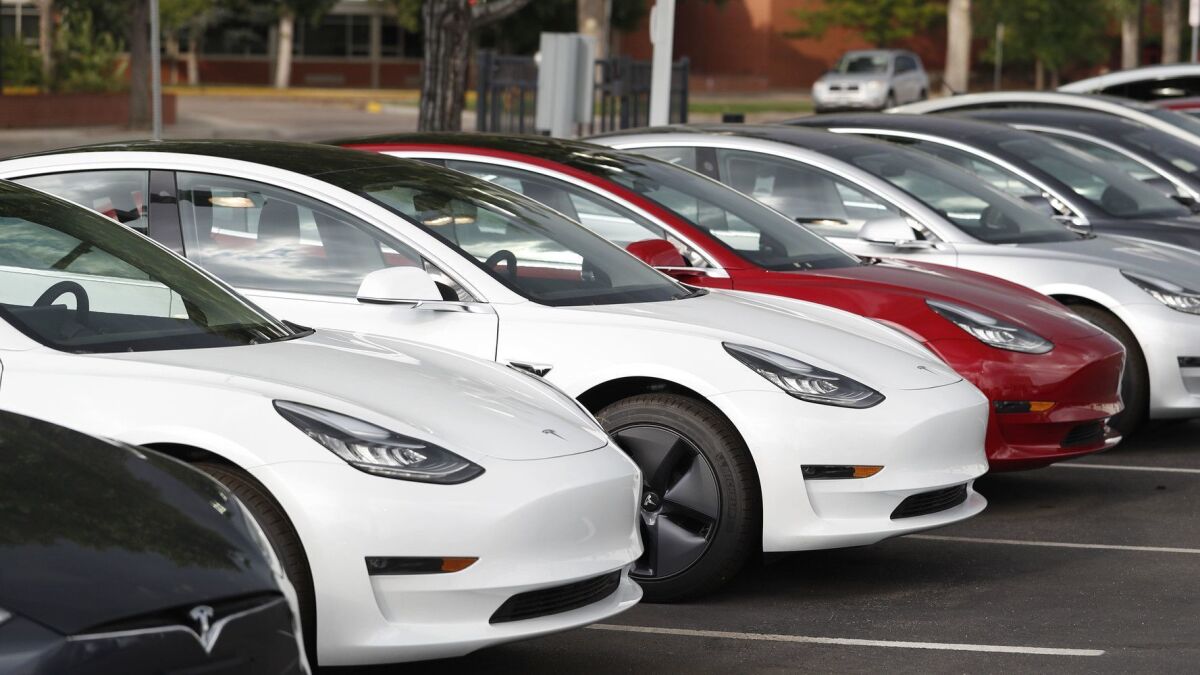 Tesla Model 3 sedans outside a Tesla showroom in Littleton, Colo., in July.