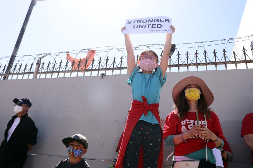 LOS ANGELES, CA - MARCH 27: People gather during a rally against anti-Asian American and Pacific Islander sentiment and hate hosted by the Korean American Federation of Los Angeles in Koreatown on Saturday, March 27, 2021 in Los Angeles, CA. Hundreds showed their support for the cause by marching down Olympic Blvd. (Dania Maxwell / Los Angeles Times)