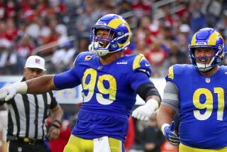 Inglewood, CA - October 30: Rams defensive tackle Aaron Donald, #99, celebrates sacking 49ers quarterback Jimmy Garoppolo.