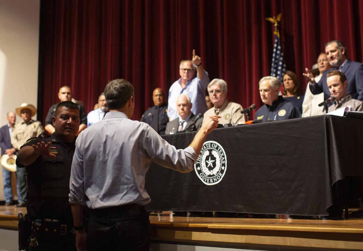 Beto O'Rourke confronts Gov. Greg Abbott during a news conference in Uvalde on May 25.