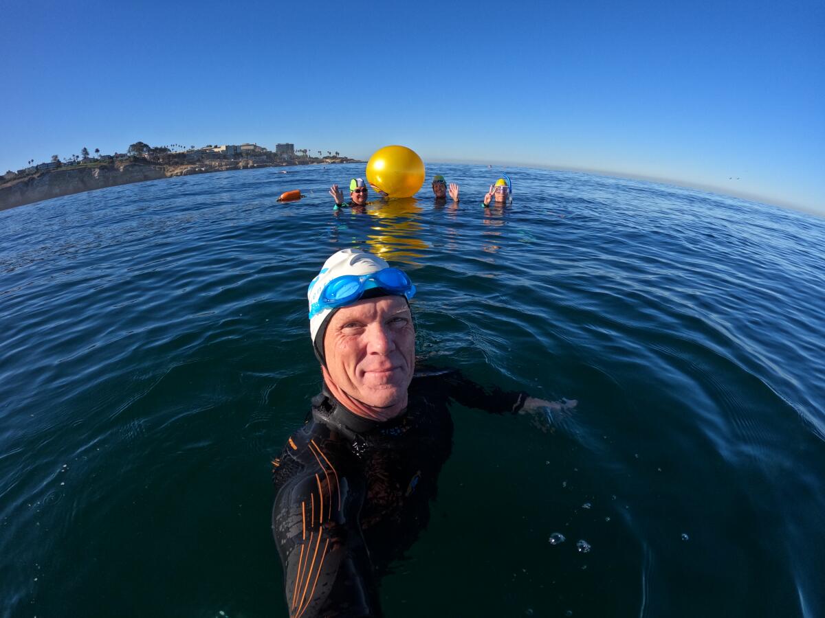 New La Jolla Cove Swim Club President John Thomas goes for a swim with friends.