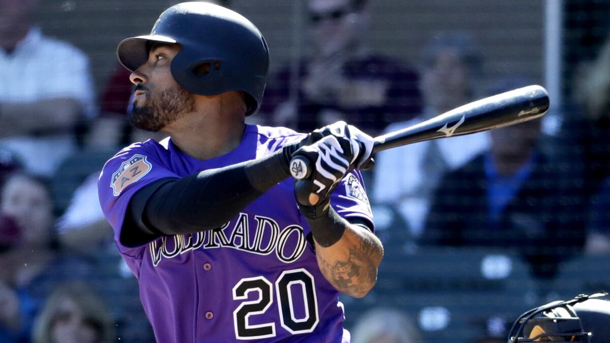 Rockies first baseman Ian Desmond takes a cut during a spring training game last month.