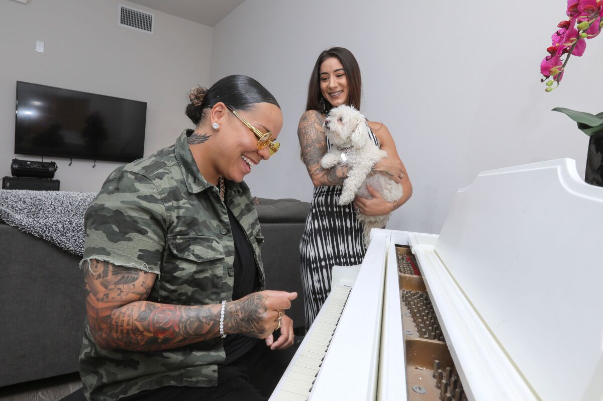 "America's Got Talent" singer Celina Graves plays her piano with wife Erica and dog Hope watching