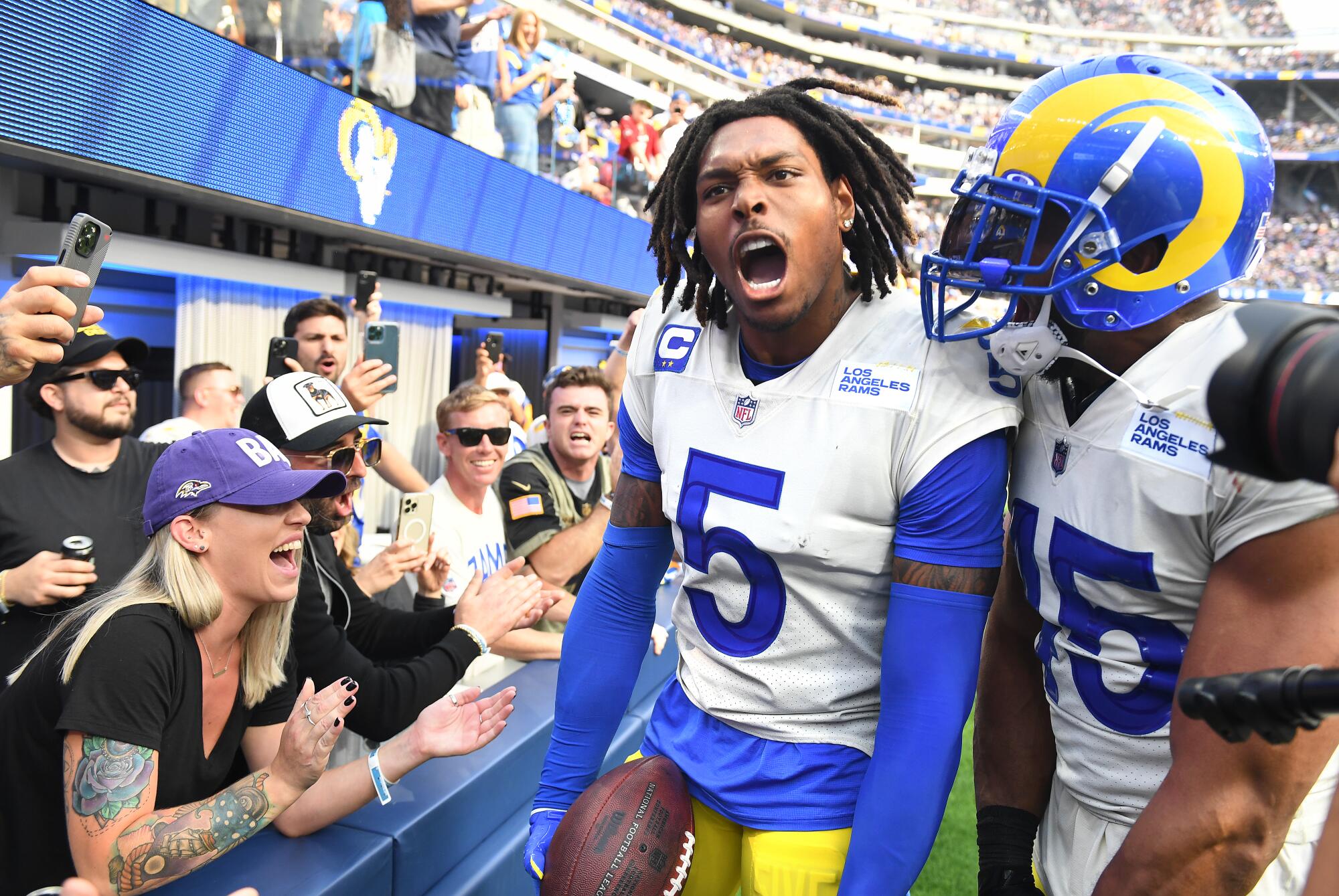 Rams defensive back Jalen Ramsey celebrates his interception in the end zone in front of linebacker Bobby Wagner.