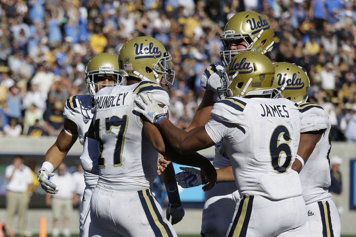 UCLA quarterback Brett Hundley (17) is congratulated by teammates after scoring on a 15-yard run against California late in the third quarter.