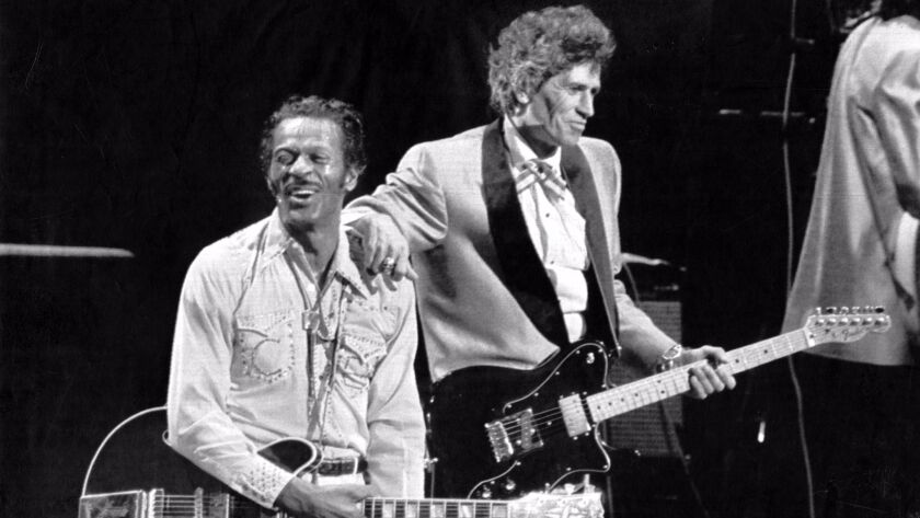 Rock 'n' roll pioneer Chuck Berry, left, was feted on his 60th birthday in 1986 by the Rolling Stones onstage in his hometown of St. Louis.