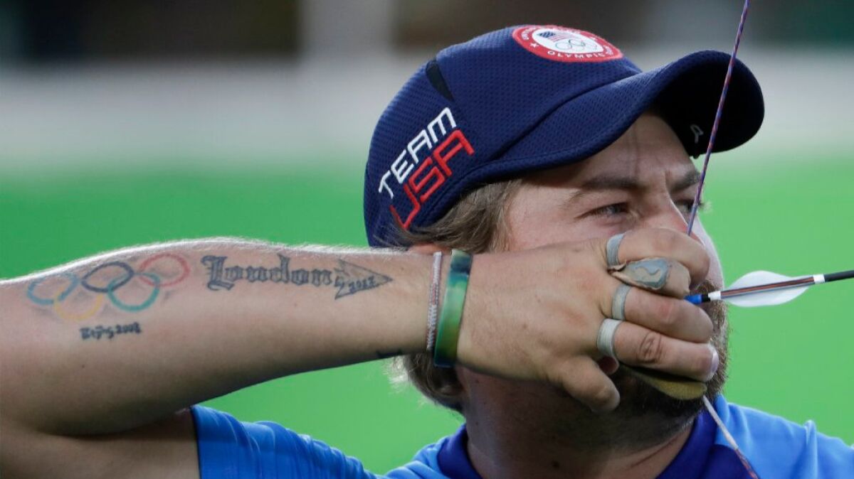 Brady Ellison of the United States releases an arrow during the men's team archery competition at the 2016 Summer Olympics on Aug. 6.