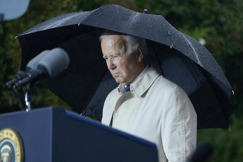 President Joe Biden stands during a moment of silence during a ceremony at the Pentagon in Washington, Sunday, Sept. 11, 2022, to honor and remember the victims of the September 11th terror attack. (AP Photo/Susan Walsh)