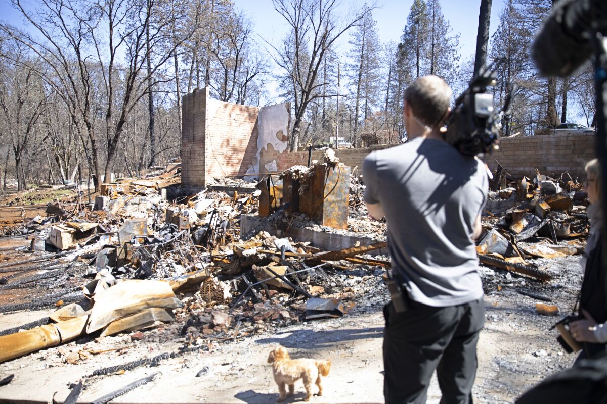 Lincoln Else, the "Rebuilding Paradise" director of photography, films debris-strewn property in Paradise, Calif.