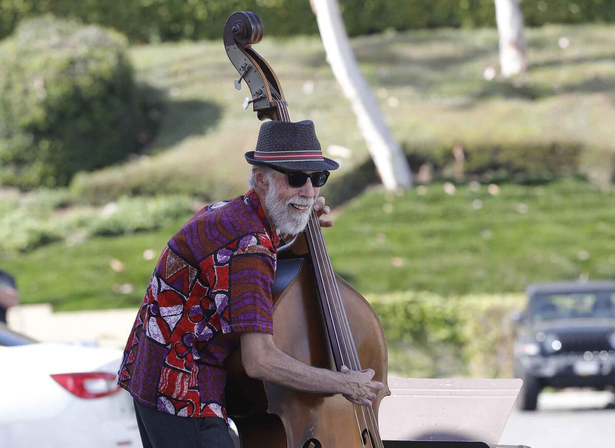 Bass player Frank Schatz of Tracy Longstreth & The Blues Makers band perform outside of the Bayside Restaurant during a drive-in concert in Newport Beach on Thursday.