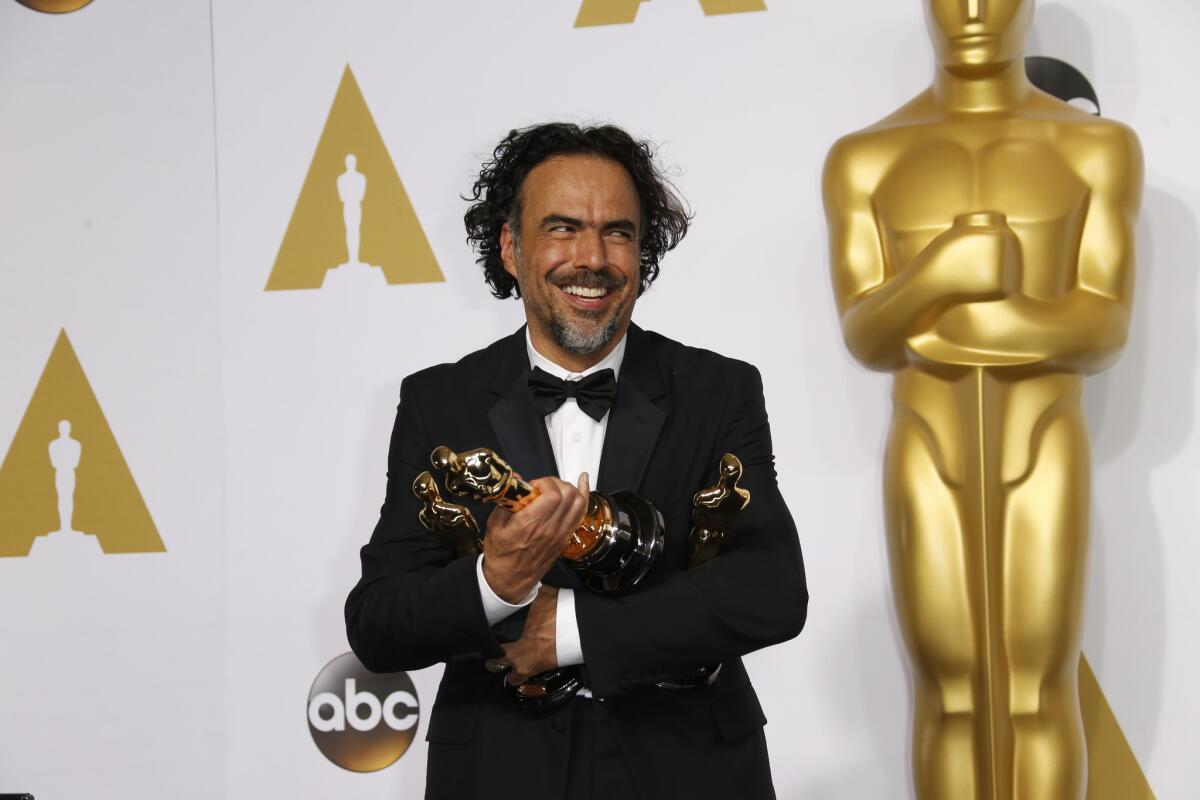 Director Alejandro Gonzalez Inarritu holds his Academy Awards for "Birdman" at the 87th annual Academy Awards on Feb. 22, 2015, at the Dolby Theatre in Hollywood.