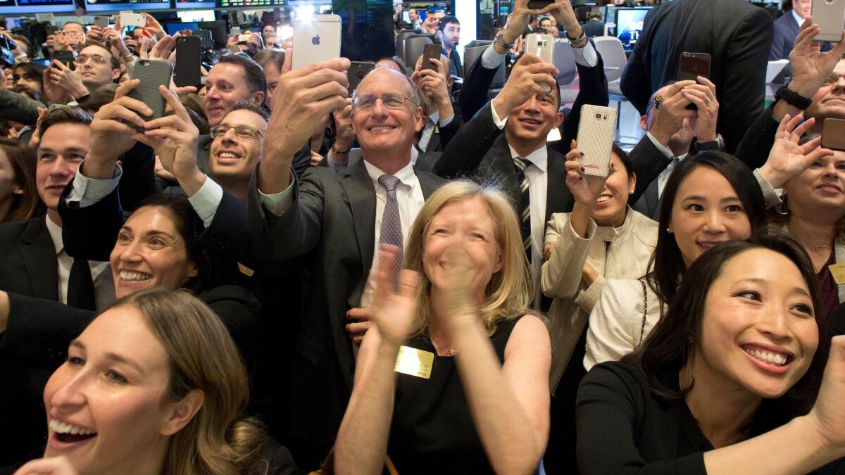 Employees of Snap Inc. and their friends celebrate as the company's co-founders ring the opening bell of the New York Stock Exchange on Thursday.