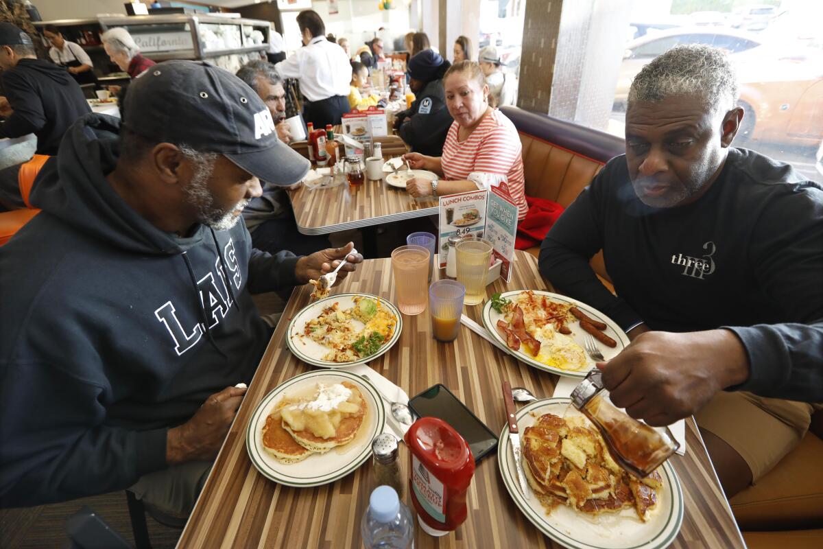 Eric Epperson, left, and Tony Jones enjoy breakfast at Norms in West Hollywood.