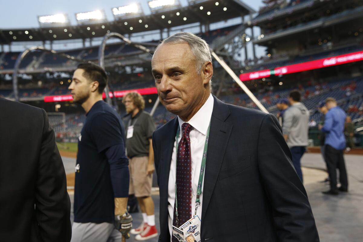  Major League Baseball Commissioner Rob Manfred walks on the field during batting practice before a National League wild-card game between the Milwaukee Brewers and the Washington Nationals on Oct. 1 in Washington. 