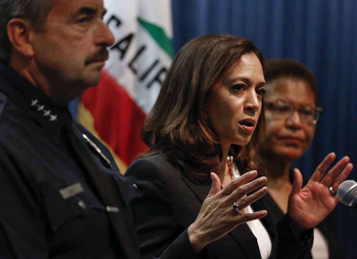 Kamala Harris, then California attorney general, appears alongside Rep. Karen Bass, right, at a news conference.