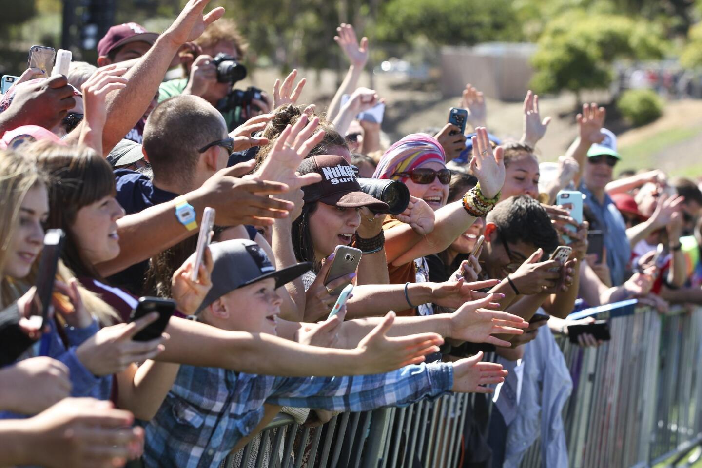 Supporters of Democratic presidential candidate Bernie Sanders reach out to shake his hand after Sanders spoke.