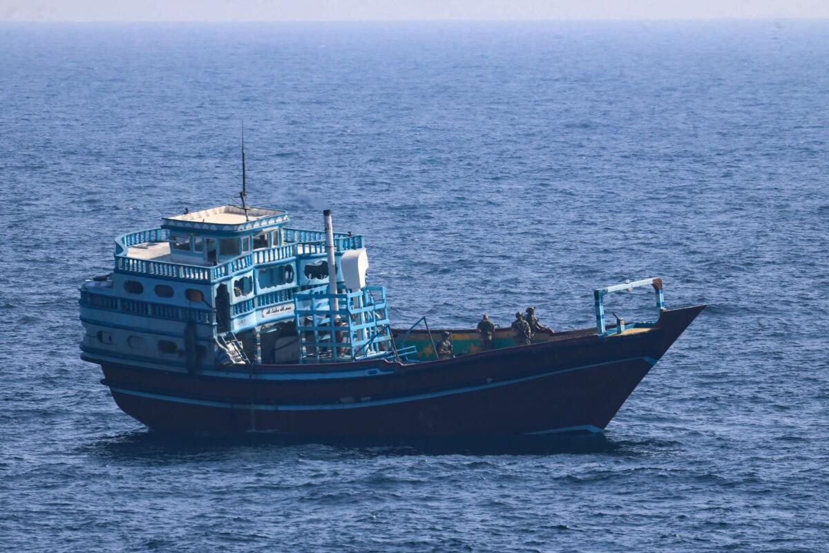 U.S. service members search a stateless fishing vessel in the Gulf of Oman