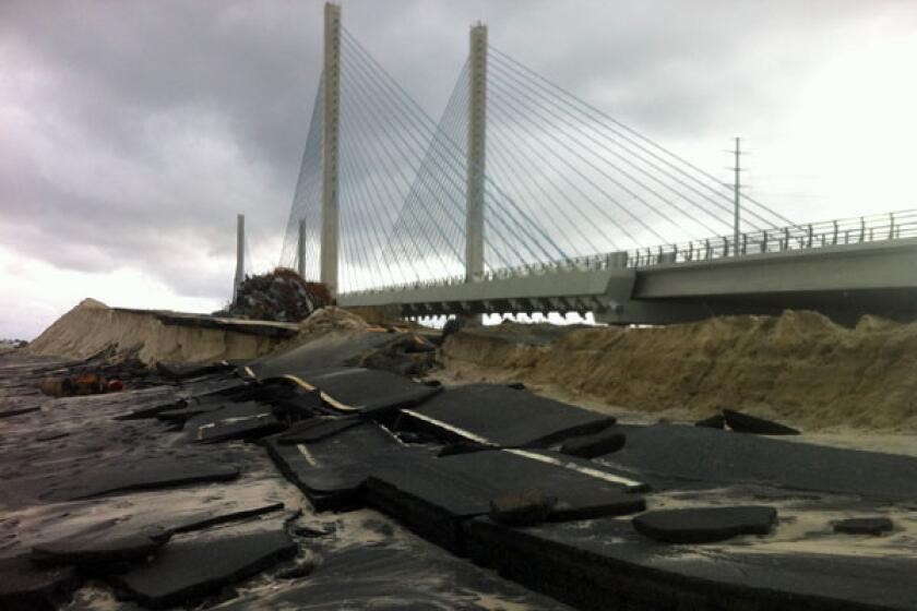 A bridge along the Delaware coast stands undamaged beside its shattered predecessor.