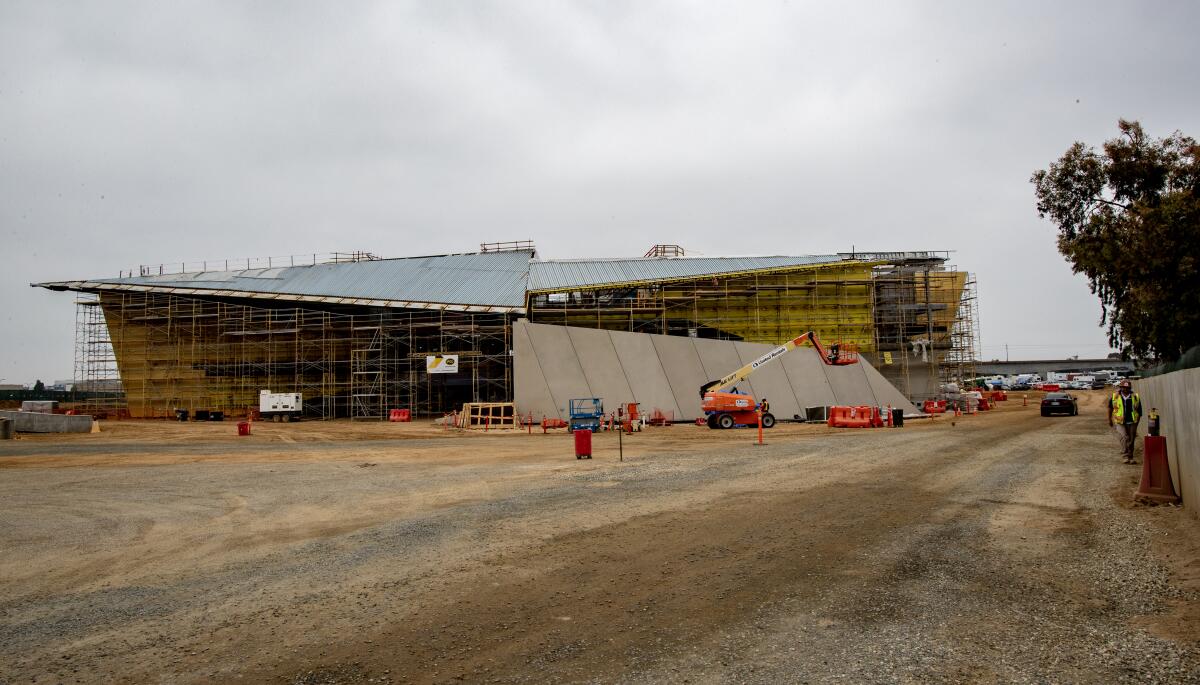 An under-construction facility covered in scaffolding.