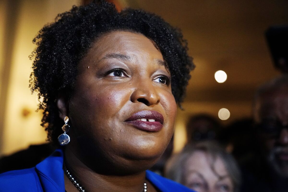 FILE - Georgia gubernatorial Democratic candidate Stacey Abrams talks to the media after qualifying for the 2022 election on March 8, 2022, in Atlanta. Abrams announced on Wednesday, May 4, 2022, that she had raised $11.7 million in three months ended April 30. (AP Photo/Brynn Anderson, File)
