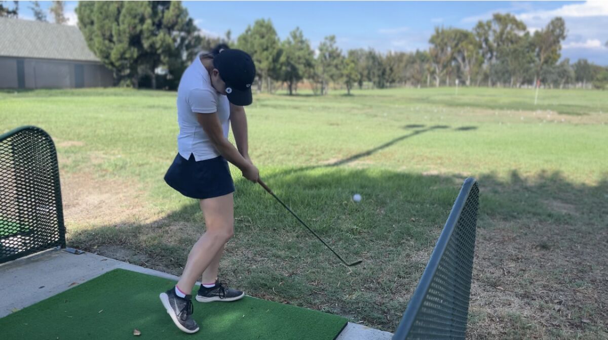 Dakota Lam takes a practice shot at Mile Square Golf Course in Fountain Valley.