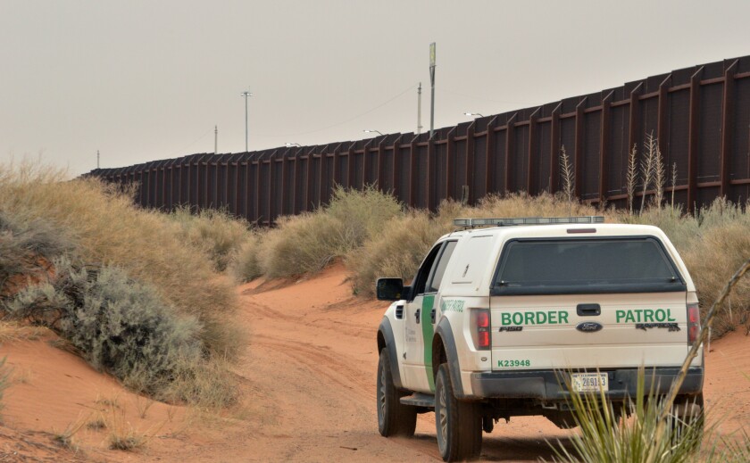 A U.S. Border Patrol agent drives near the U.S.-Mexico border fence in Santa Teresa, N.M.