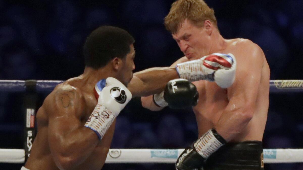 Anthony Joshua connects against Alexander Povetkin during their heavyweight title fight on Saturday night at Wembley Stadium.