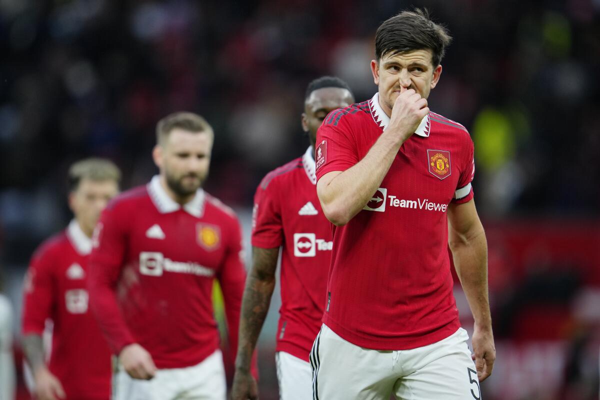 Manchester United's Harry Maguire grimaces on the halftime during the English FA Cup quarterfinal soccer match between Manchester United and Fulham at the Old Trafford stadium in Manchester, England, Sunday, March 19, 2023. (AP Photo/Jon Super)